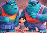 a girl is standing between two monsters from the movie monsters inc.