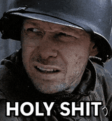 a man wearing a helmet says holy shit on the bottom