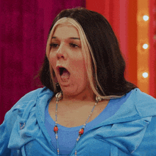 a woman with her mouth open wearing a blue shirt