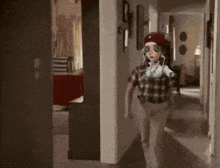 a cartoon character with green eyes is standing in a dark room .