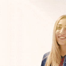 a woman wearing a blue nuna shirt smiles