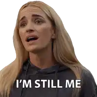 a woman says i 'm still me while wearing a grey hoodie