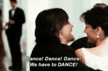 a man and a woman are dancing and the man says " dance "