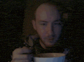 a man is eating cereal with a spoon from a bowl