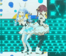 two anime girls are dancing on a stage in front of a blue background .