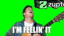 a man playing a guitar with the words i 'm feelin ' it
