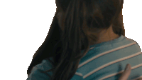 a woman in a blue striped shirt is hugging a child