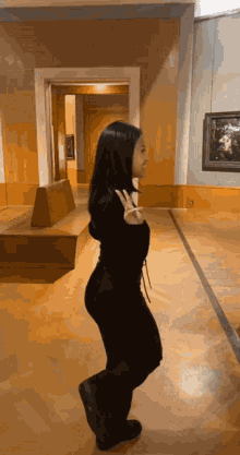 a woman giving a peace sign in a hallway