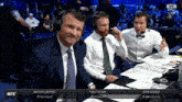 a group of men are sitting in front of a screen that says ufc live