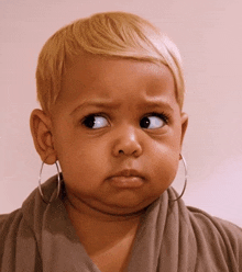 a little girl with hoop earrings on her ears