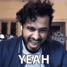 a man with a beard is making a funny face and the word yeah is on his face