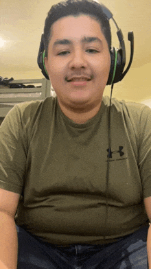 a man wearing a green under armour shirt