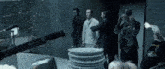 a group of people standing around a stack of plates in a dark room .