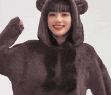 a woman wearing a bear costume with a hood and ears