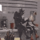 a blurred image of a man and a woman sitting at a table in a room