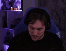 a man wearing headphones is brushing his teeth with a white toothpaste