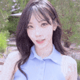 a close up of a woman wearing a blue top