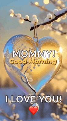 a heart shaped ornament hanging from a tree branch with the words `` mommy ! good morning i love you '' written on it .