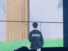 a man standing in front of a screen with the letter e on the back of his jacket