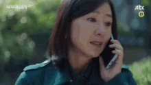 a woman is talking on a cell phone .