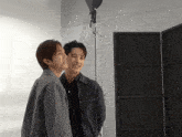 two men are standing next to each other and smiling for the camera