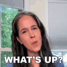 a woman says what 's up while looking at the camera