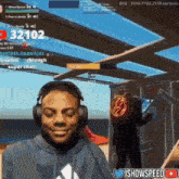 a man wearing headphones is smiling in front of a screen that says ' ishowspeed ' on it