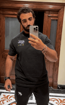 a man taking a picture of himself in a mirror with his phone