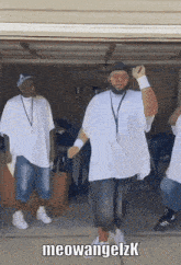 a group of men are dancing in a garage with the name meowangelzk on the bottom right