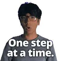 a man wearing glasses and a gray shirt says one step at a time