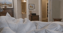 a bedroom with a dresser and a picture on the wall that says ' seagulls '