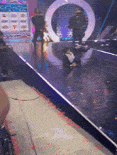 a man is laying on the floor on a stage in front of a slot machine that says 7