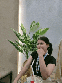 a girl sitting at a table with a lanyard around her neck that says " sidecall "