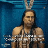 a man dressed as a native american with feathers on his head says gila river translation : chandler but south
