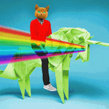 a cat is riding a green origami unicorn