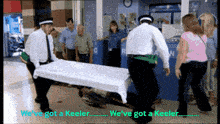 a man is carrying a stretcher with the words we 've got a keeler