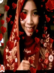 a woman wearing a red scarf with the name nisah on it