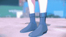 a person wearing a pair of blue boots