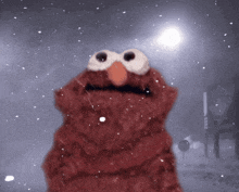elmo from sesame street stands in the snow