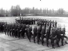 a black and white photo of a military parade .