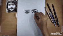 a person is drawing a girl 's face with a pencil