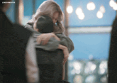 a woman is hugging a man in a blurry photo with the words lingormgifss above her