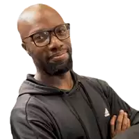 a bald man wearing glasses and a black adidas shirt