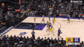 a basketball game is being played in front of a crowd and the score is 89 to 82