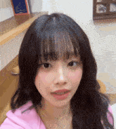 a close up of a girl 's face with a book behind her
