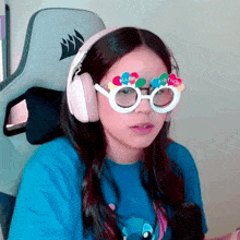a girl wearing headphones and a pair of glasses that say happy birthday