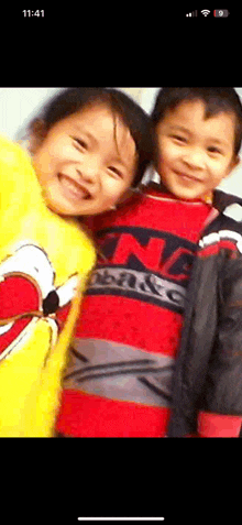 a boy and a girl are posing for a picture and the girl is wearing a shirt that says ' king '