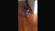 a little boy is playing with a toy car on the floor