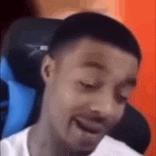a man is sitting in a chair with his eyes closed .