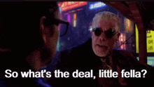 a man wearing sunglasses is talking to another man and the words so what 's the deal little fella